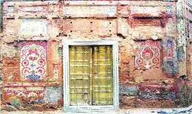 A view of the damaged priceless frescoes on the walls of Baba Atal