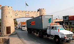 Pakistani drivers drive their containers through Khyber Pass as they carry supplies for NATO and the US-led forces in Afghanistan, in the border town of Jamrud