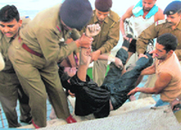 Policemen fish out the body of Vikas from Sukhna Lake on Tuesday.