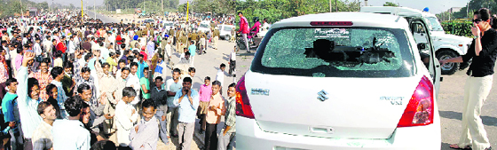 Residents block traffic on the dividing road of Sectors 44-51 in Chandigarh on Tuesday; and (right) the damaged car at the road facing Colony No. 5.