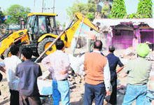 An encroachment is demolished along NH-1 between Namaste Chowk and Maduban in Karnal on Tuesday.