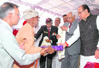Haryana Governor A.R. Kidwai honours an ex-serviceman at a function to pay tributes to the Rezangla martyrs in Gurgaon on Tuesday.