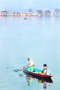 A Kashmiri woman and her child enjoy boating in Srinagars Dal Lake