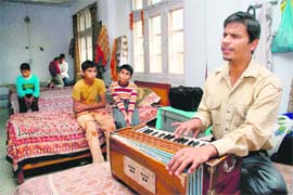 Rahul Kumar Bhagat sings a song in his school room .