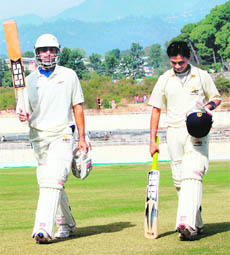 Sangram Singh (L) and Vinit Indulkar return back to pavilion after Himachal declared their innings closed against J&K at Dharamsala on Tuesday Sangram scored 215 while Indulkar also hit a century (109).