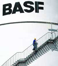 This file photo shows an employee of German chemicals company BASF walking up the stairs of an oil tank at the company's plant in Schwarzheide, eastern Germany. The world's biggest chemical company, BASF, said on Wednesday it would cut its production worldwide and suspend operations at 80 plants, affecting 20,000 workers.