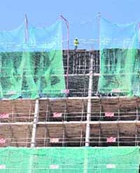 A worker stands on the top of a construction site in Madrid on Wednesday. Spain's economy contracted for the first time since 1993 in the third quarter, final official data showed on Wednesday, and analysts were taken aback by the speed with which a house slump is sapping consumer spending.
