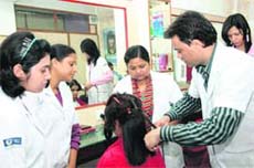 Students of VLCC learn the basics of hair designing. 