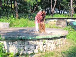 A resident of Chari village showing the water tank which has not been used for purification of water for long. 