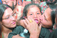 Arshnoor being kissed by a relative after he was handed over to his parents by the police as his mother (left) looks on adoringly at their residence in Santokhpura in Jalandhar on Wednesday.