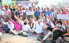 Congress councillors and residents stage a dharna at Haibowal on Wednesday.