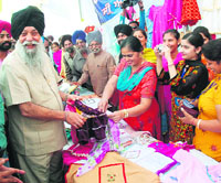 Capt Kanwaljit Singh, cooperative minister, shares a light moment with members of a coop group society on the occasion of Cooperative Week in Jalandhar on Wednesday.