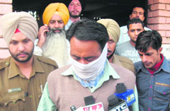 Kingpin of the passport scam head constable Jaswinder Pal Singh talks to mediapersons in Moga on Wednesday.