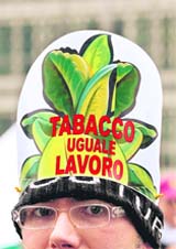 A protester wears a hat reading Tobacco means labour as tobacco growers demonstrate outside a European Agriculture and Fishery Ministers Council in Brussels