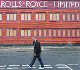 A man walks past a closed Rolls -Royce building in Derby, central England, on Thursday.
