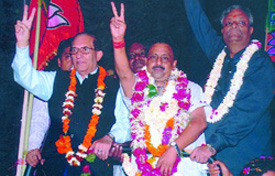 (Left) Chief Minister Sheila Dikshit campaigns in the New Delhi area. 