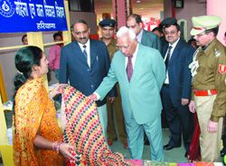 Haryana Governor A.R. Kidwai looks at a product of Women Self Help Groups displayed at the Haryana pavilion during IITF-2008 at Pragati Maidan in New Delhi on Thursday.