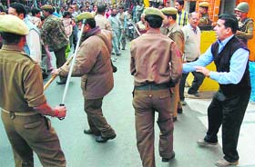 Policemen canecharge striking members of the J&K Joint Action Committee in Jammu