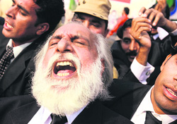 A lawyer shouts slogans during a protest against the US air strikes in Pakistans tribal areas, in Lahore on Thursday. 