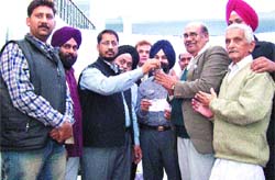 Anil Joshi, MLA, hands over the keys of shops to the allottees in Amritsar