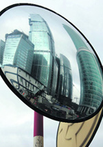 This file photo shows the site for construction of the Russia Tower reflected in a traffic safety mirror in Moskva city, Moscow. Global financial turmoil has forced a Russian property developer to suspend construction of a Moscow skyscraper called the Russia Tower that is planned to be Europe's tallest building, Interfax news agency reported on Friday. 