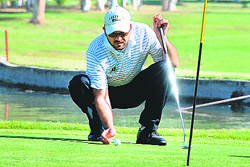 An NRI marks as his shot lands just 2 feet away from the hole on the opening day of the Chandigarh Golfing Tour on Friday. 