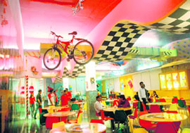 Tracks on the walls and hanging sports gear evoke the feel of a race course.