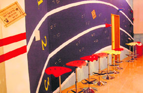 Tracks on the walls and hanging sports gear evoke the feel of a race course.