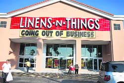 Customers walk away after shopping at the going-out-of-business sale at Linens 'N Things in Miami, Florida