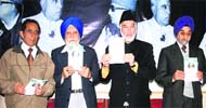 Muzzaffar Shah (second from right), senior leader of the Awami National Conference, releases election manifesto in Jammu