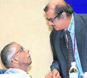 National security adviser M.K. Narayanan talks with Union cabinet secretary K.M. Chandrasekhar during the DGPs/IGPs conference at Vigyan Bhawan in New Delhi