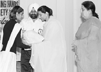A giddha performer receives an award during a cultural programme in Patiala on Sunday.