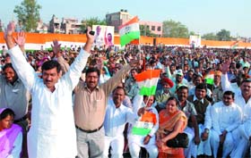 Supporters of Congress listen to a speech by party president and chairperson of the United Progressive Alliance (UPA) government, Sonia Gandhi during a public meeting in favour of Congress candidates for Delhi assembly election at Mangolpuri in New Delhi