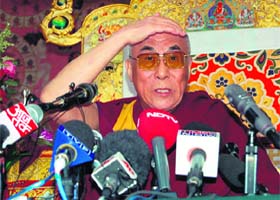The Dalai Lama addresses a press conference at his main temple at McLeodganj
