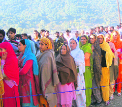 Women voters outside a polling station in Rajouris Dharal constituency on Sunday.