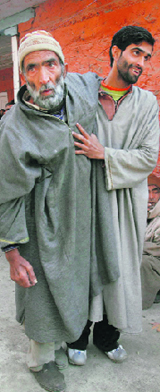 A relative helps the old man after casting vote in second phase at Lar, 35 km from Srinagar, on Sunday.