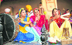 Girls spin a charkha (wheel) at the fifth heritage fair being organised at Jaipalgarh village in Bathinda