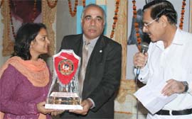 A paramedical worker being honoured for rendering her services during the free surgical camp at Sai Temple in Abohar on Monday night.