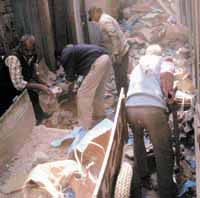 Workers remove debris near G.B. Road in New Delhi on Monday. 
