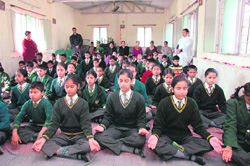 Students of Greenfield School attend yoga classes in the school premises on Monday. 