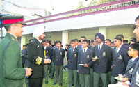 Vice Admiral B.S. Randhawa interacts with cadets at RIMC in Dehradun on Monday.