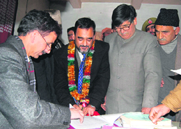 Senior party leader Ghulam Navi Wani of the National Conference signs nomination papers for the Pulwama constituency seat, some 55 km from Srinagar, on Monday.
