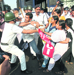 Activists of the Socialist Unity Centre of India (SUCI) scuffle with policemen during a protest against the rise in price of essential commodities in Kolkata on Monday.