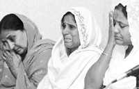 Widows of 1984 riot victims break down during a press conference in New Delhi on Monday in which they expressed their anger against the Congress.