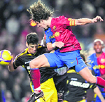 Barcelonas Carlos Puyol (right) duels for the ball with Getafes Jaime Gavilan during a Spanish League soccer match at Camp Nou Stadium in Barcelona on Sunday.