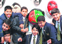 The budding artists of St John's pose with their masks.