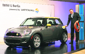 Norbert Reithofer, chairman of the board of management of BMW AG, plugs in a Mini-E electric car at its launch at the British embassy in Berlin on Tuesday.