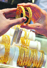 A woman looks at gold bangles at a jewellery store in Hyderabad on Tuesday.