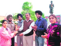 Meenakshi being felicitated by MM Modi College principal Satish Kumar in Patiala on Tuesday. 