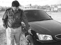 SP (Detective), Mohali, R.K. Bakshi shows, the bullet mark on a car in Zirakpur on Tuesday. 